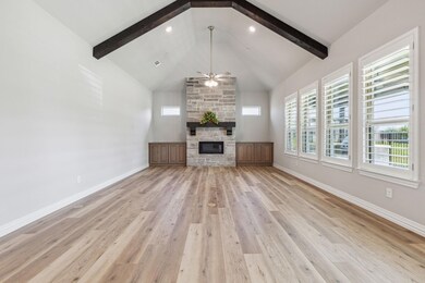 Unfurnished living room with ceiling fan, a firepl