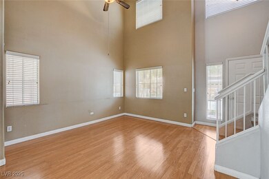 Unfurnished room with a ceiling fan, a high ceilin