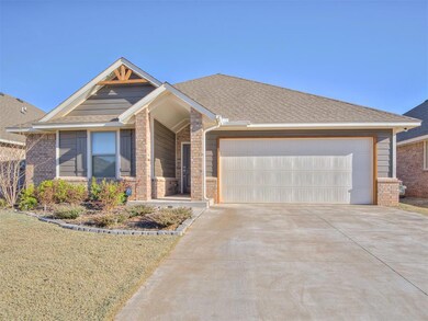 View of front of home featuring a garage, brick si