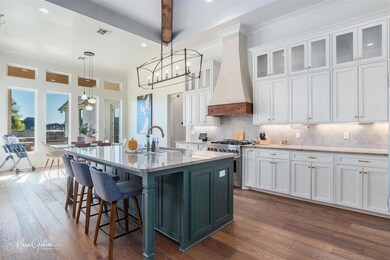 Kitchen with custom exhaust hood, high end stove, 