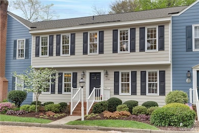 View of colonial inspired home, nicely landscaped
