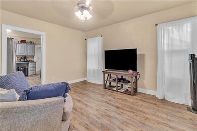 Living room with light hardwood / wood-style floor
