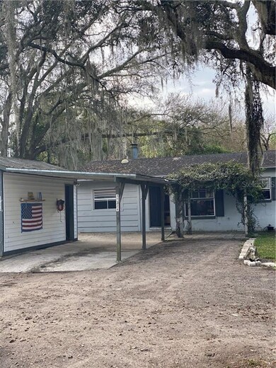 Front of home with carport, workshop and outside entertaining are under plant covering.