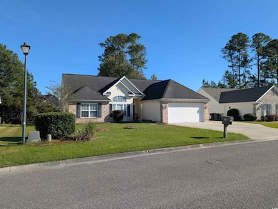 Single story home featuring a front lawn, concrete driveway, brick siding, an attached garage, and roof with shingles