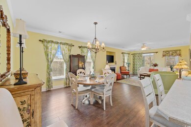 Dining area featuring dark wood-style flooring, a 