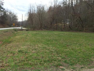 Paved road frontage with stream and wooded bufferi