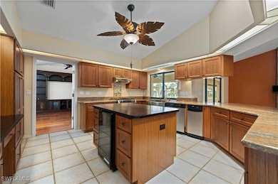 Gas Range, stainless farm sink, view to pool/lanai