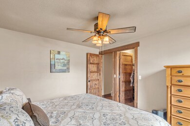 Bedroom featuring a textured ceiling and a ceiling fan