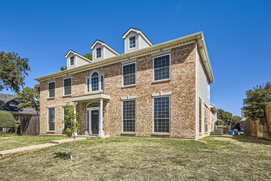 Colonial home featuring central air condition unit