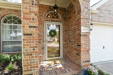 The front porch has a lovely brick archway to invi