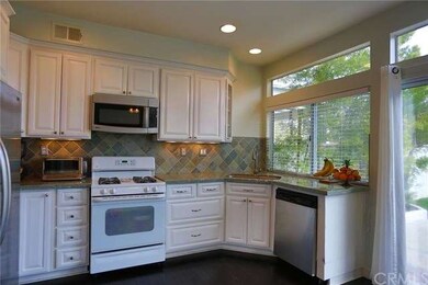 The kitchen showing the stainless dishwasher and c