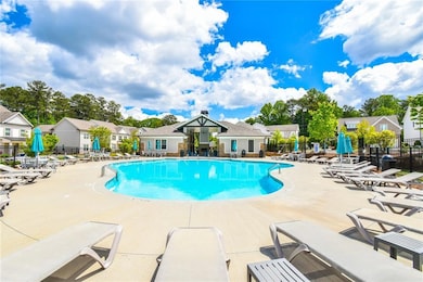 Pool with a patio area, fence, and a residential v