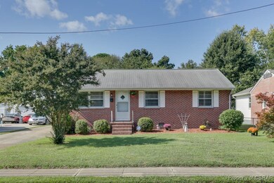 Ranch-style home featuring a front lawn