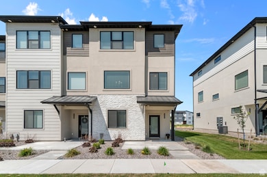 Contemporary home with a standing seam roof, a metal roof, and stucco siding