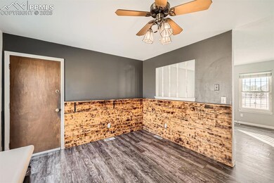Empty room with ceiling fan, wood finished floors,