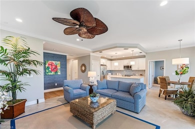 Living area featuring crown molding, baseboards, r