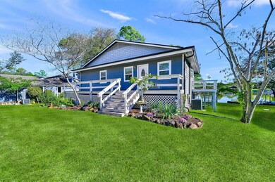View of front of house with a deck with water view