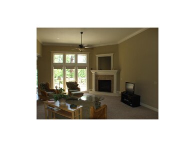 Main floor living room with fireplace. Windows ove