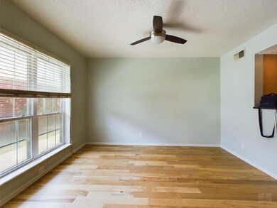 Unfurnished room featuring visible vents, a wealt