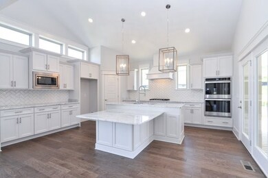 Beautiful Gourmet Kitchen with Built In Double Ovens and Large Island. This photo is not of actual home. For representation only. 