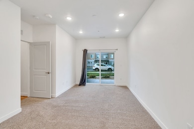 Empty room featuring light colored carpet and recessed lighting