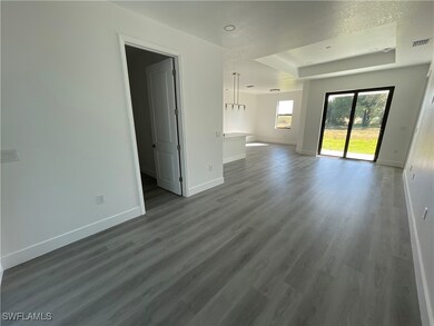 Unfurnished living room featuring a textured ceili