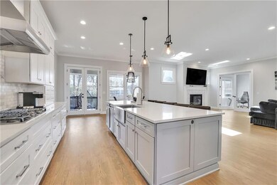Kitchen featuring white cabinetry, light hardwood 