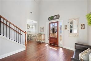 Entryway with baseboards, a high ceiling, wood fin