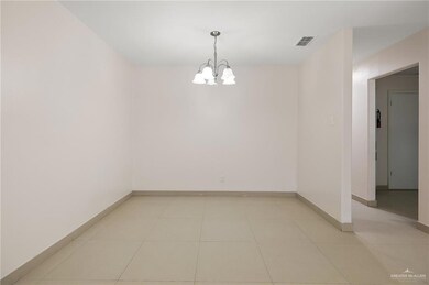 Unfurnished room with light tile patterned floors, visible vents, baseboards, and an inviting chandelier