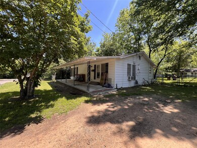Back of property featuring a lawn