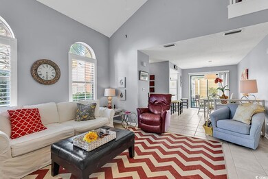 Living room with light tile patterned floors and h