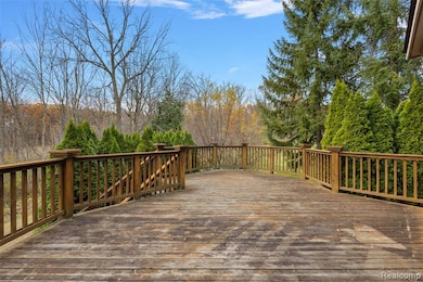 Wooden deck featuring a view of trees