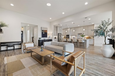 Living room with recessed lighting, visible vents