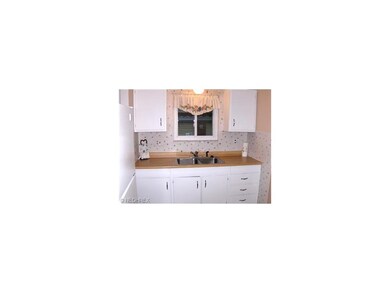 The cheery step-saving kitchen boasts white cabine