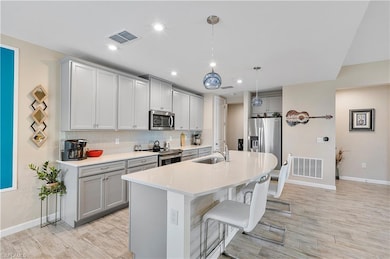 Kitchen featuring a kitchen bar, hanging light fix