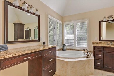 Renovated master bathroom with dual vanities, soaking tub, large shower, two tower storage cabinets and beautiful tile floors.