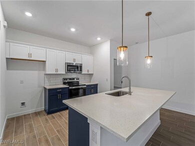 Kitchen with stainless steel appliances, a sink, b