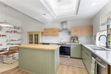 Kitchen with wall chimney exhaust hood, stainless