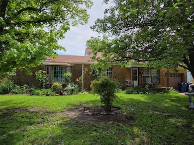 Ranch-style house with brick siding and a front la