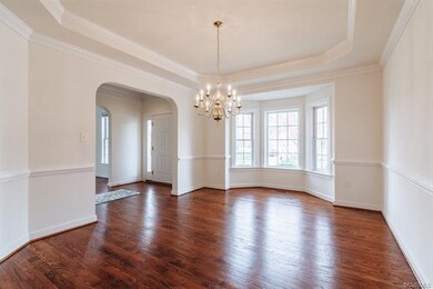 Formal dining room with a bright bay window, octag