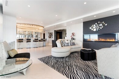 Living room featuring a glass covered fireplace an