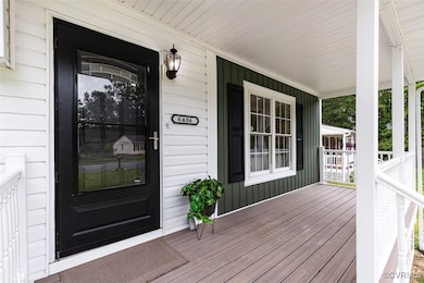 View of exterior entry with covered porch