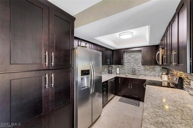 Kitchen with dark brown cabinets, appliances with