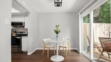 Dining room with dark wood-type flooring and base