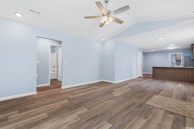 Unfurnished living room featuring lofted ceiling, 