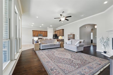 Living room featuring visible vents, a ceiling fan