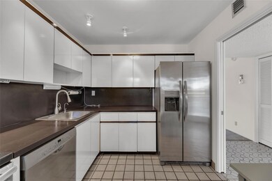Kitchen with white cabinets and stainless steel ap