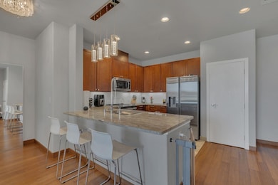 Kitchen featuring a peninsula, appliances with sta