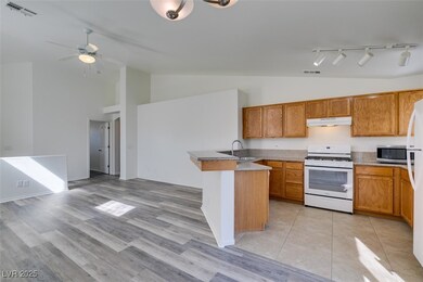 Kitchen featuring stainless steel microwave, under