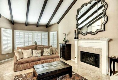 Formal living room with dark wood beamed ceilings,